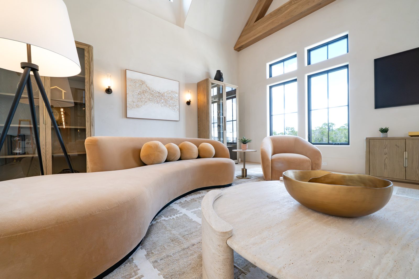 Curved sofa living room with warm coastal styling