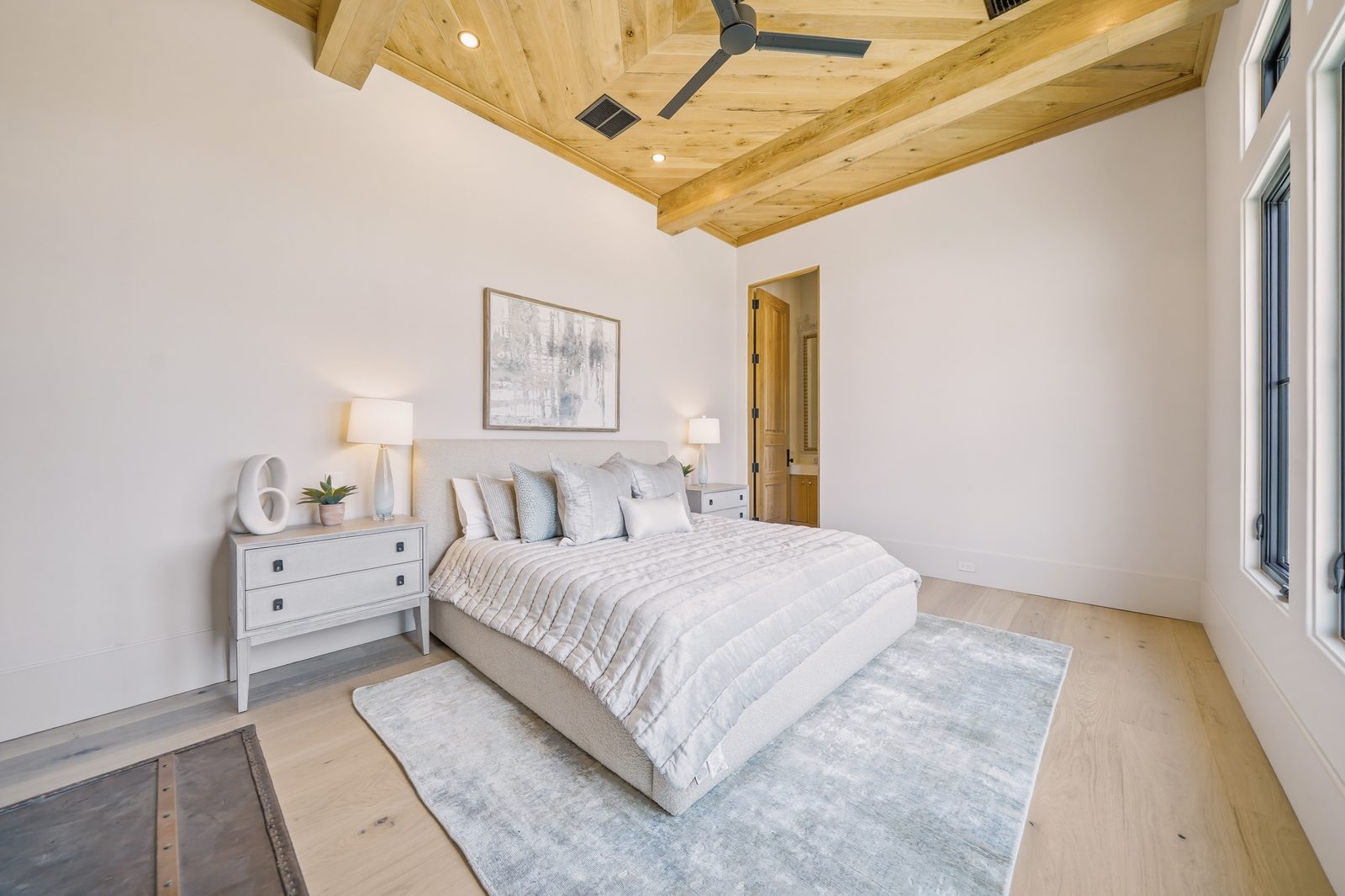 Primary bedroom with wood beam ceiling