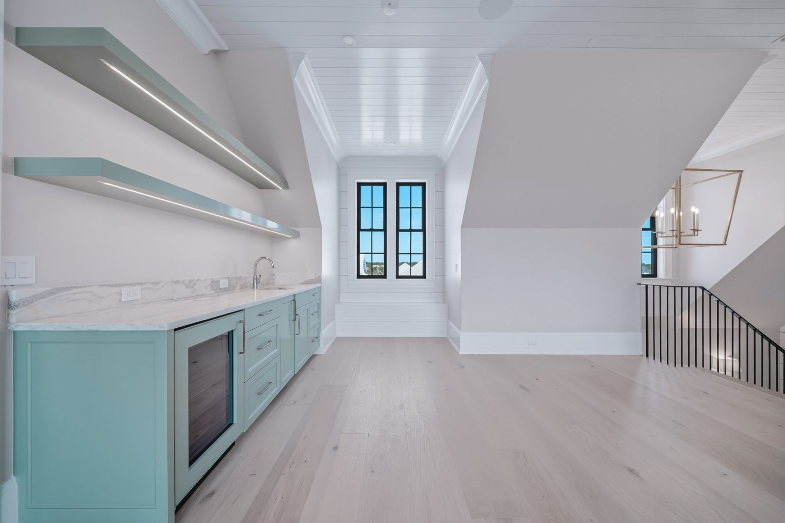 Bonus room wet bar with teal cabinetry