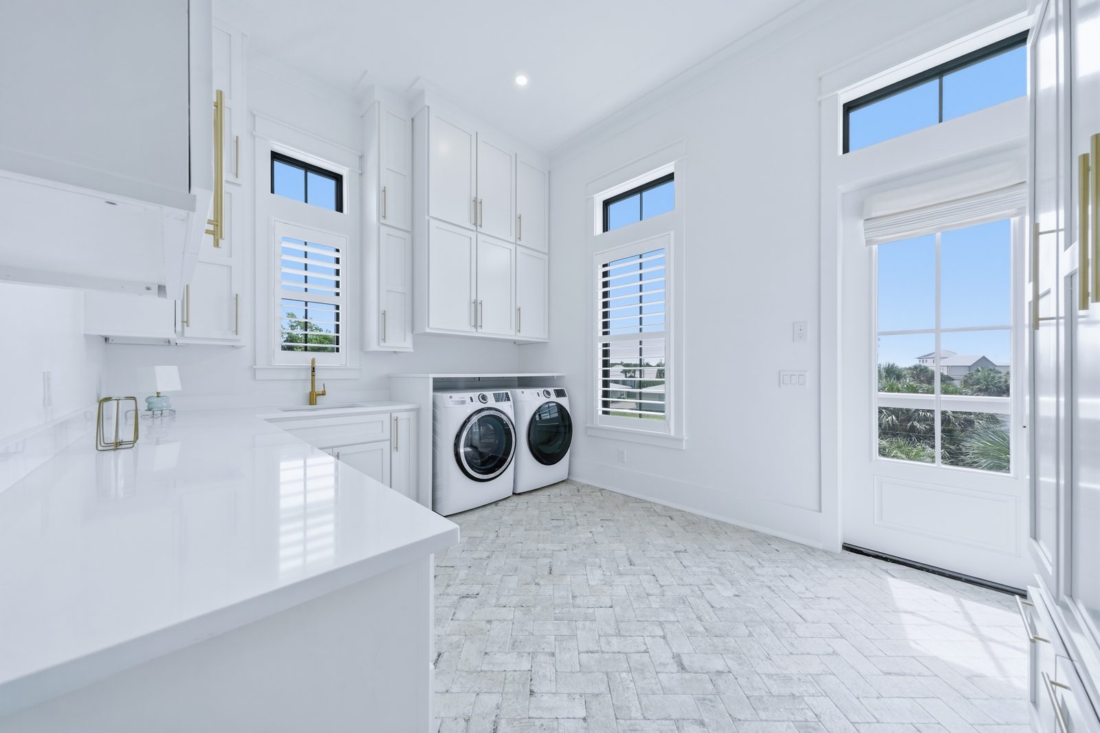 Laundry room with brick tile flooring